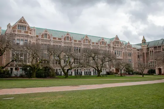 Brick and stone university hall with a long lawn