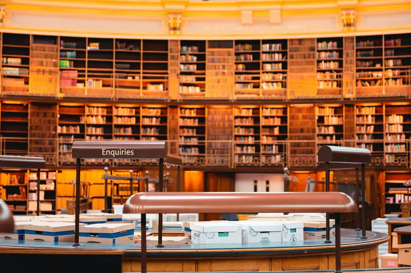 A grand library hall with tall shelves and long reading tables